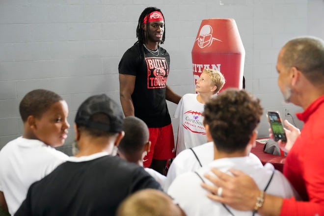 Jul 21, 2023; Columbus, Ohio, USA;  Ohio State Buckeyes wide receiver Marvin Harrison Jr. takes photos and signs autographs for kids at a football camp following his summer workout at the Woody Hayes Athletic Center.