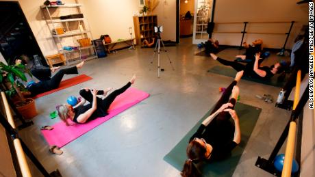Martina Knight instructs a smaller barre class, with participants observing social distancing, at the SLO Yoga Center in San Luis Obispo, California, on March 3, 2021.
