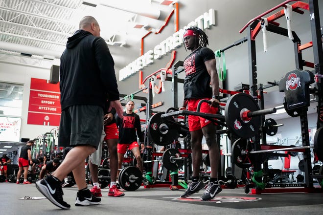 Jul 21, 2023; Columbus, Ohio, USA;  Ohio State Buckeyes wide receiver Marvin Harrison Jr. lifts under the supervision of assistant athletic director for football sports performance Mickey Marotti during a summer workout at the Woody Hayes Athletic Center prior to the start of fall camp.