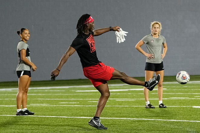 Jul 21, 2023; Columbus, Ohio, USA;  Ohio State Buckeyes wide receiver Marvin Harrison Jr. kicks a soccer ball with members of the women’s soccer team during a summer workout at the Woody Hayes Athletic Center.