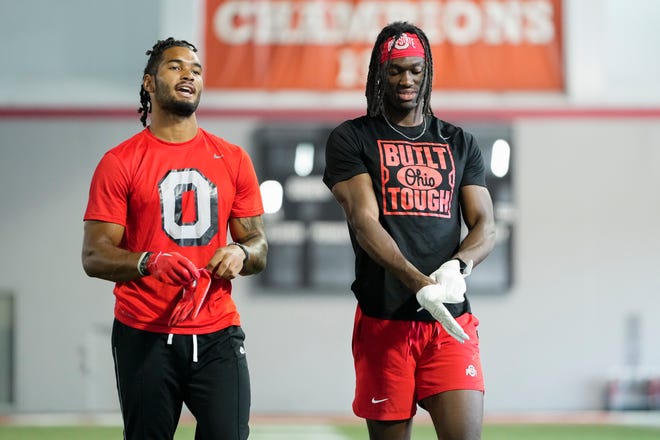 Jul 21, 2023; Columbus, Ohio, USA;  Ohio State Buckeyes wide receivers Marvin Harrison Jr. and Emeka Egbuka prepare to catch balls during a summer workout at the Woody Hayes Athletic Center prior to the start of fall camp.