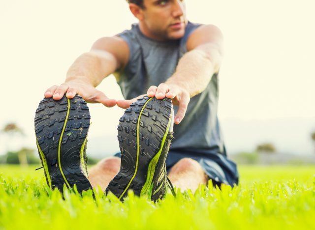 fitness man in his 20s stretching