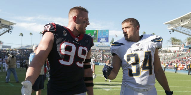Houston's J.J. Watt (99) and brother Derek Watt of Los Angeles walk off the field following the Texans' 27-20 victory over the Chargers at Dignity Health Sports Park on Sept. 22, 2019, in Carson, California. 