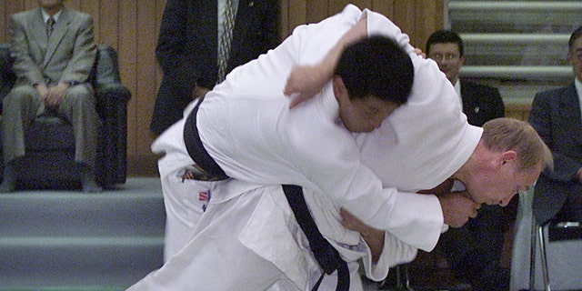 Russian President Vladimir Putin throws a Japanese judo expert during a judo exercise at Kodokan Sept. 5, 2000 in Tokyo.