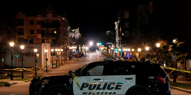 A police car is seen at Main Street in downtown Waukesha after a car plowed through a holiday parade in Waukesha, Wisconsin, on Nov. 22, 2021.  REUTERS/Cheney Orr